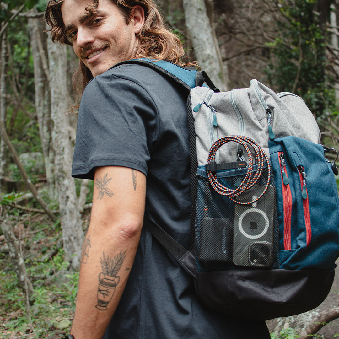 Man charging his iPhone while hiking with the Rugged Kevlar USB A to Lightning Cable