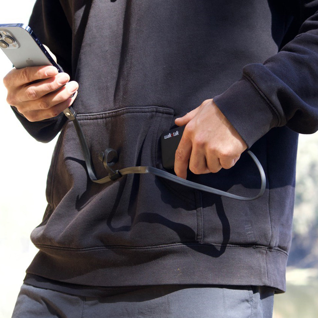 Man charging his phone with a 6 in 1 Travel Cable