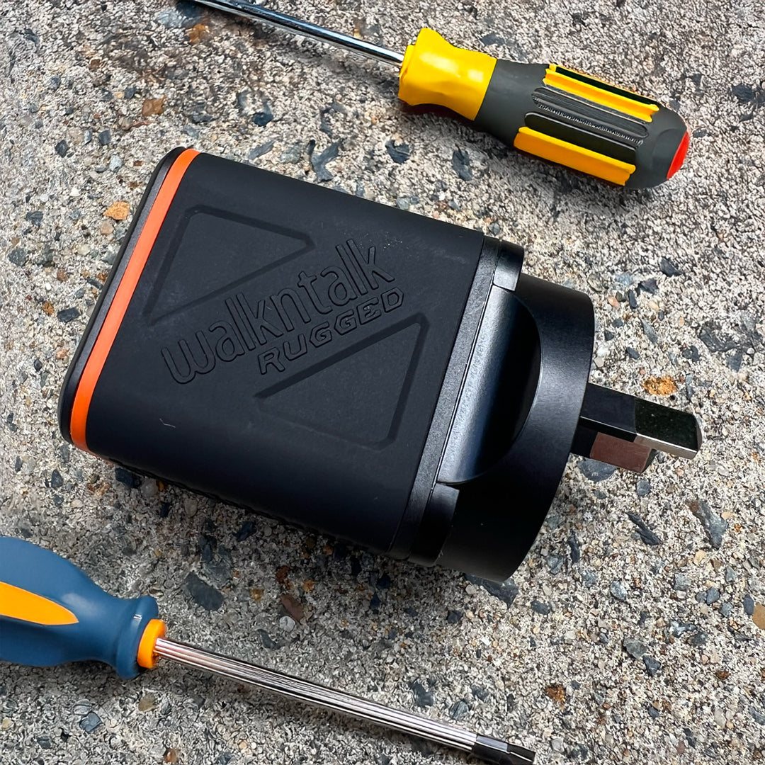Rugged Dual USB Wall Charger next to some tools