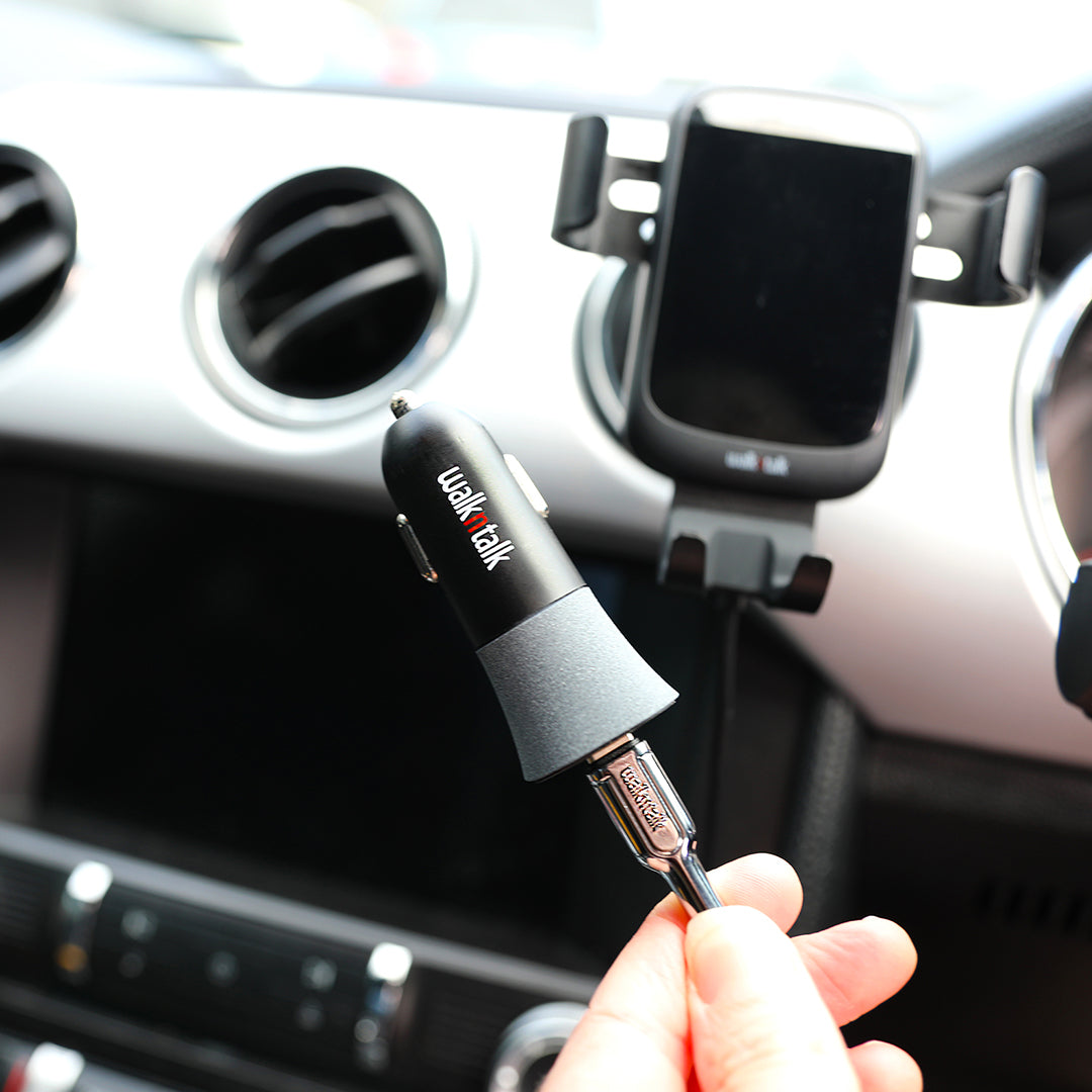 Woman holding a 48W iPhone and Samsung Fast Charge Dual USB Car Charger in a car