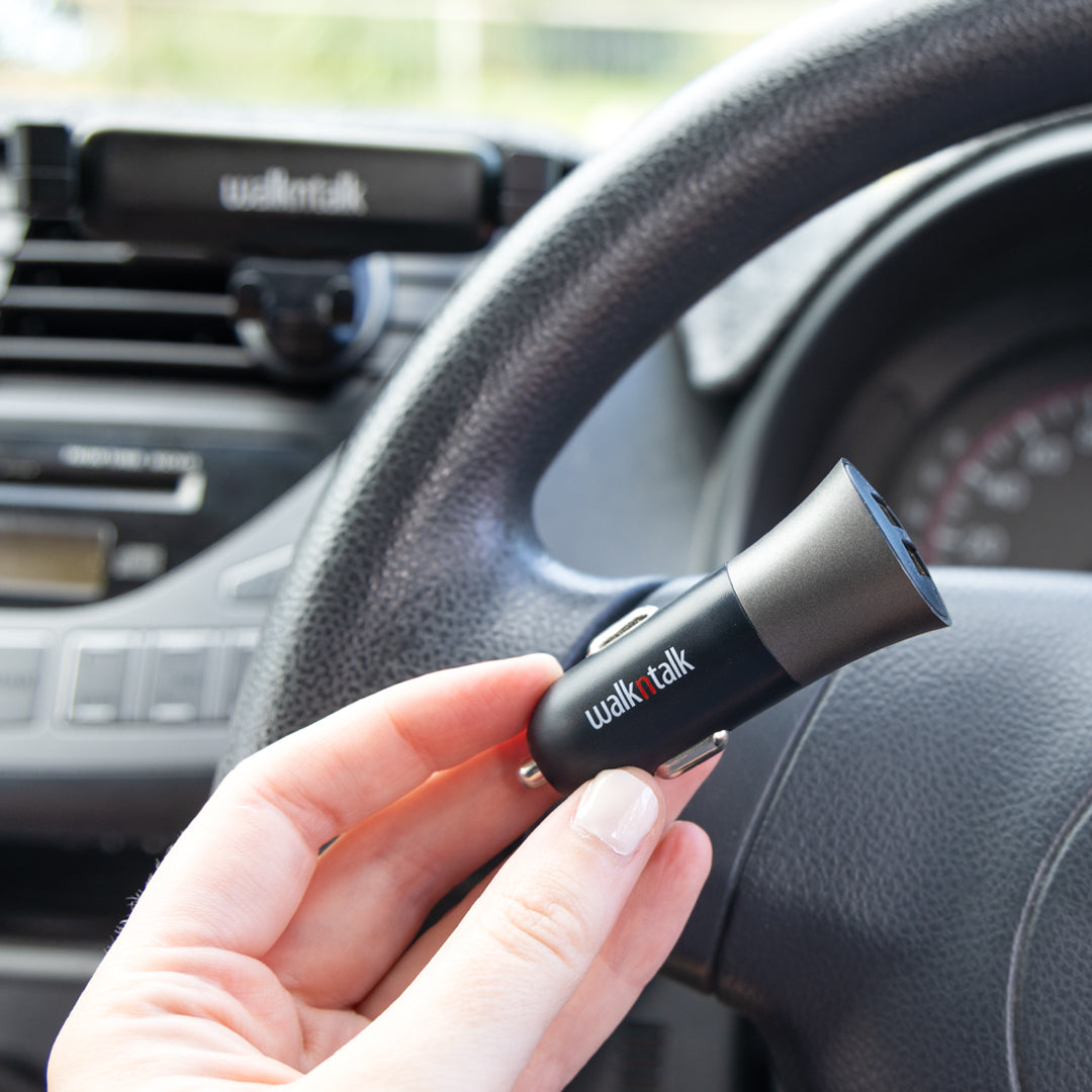 Woman holding a Car Charger Bullet Dual USB 4.8A in her car
