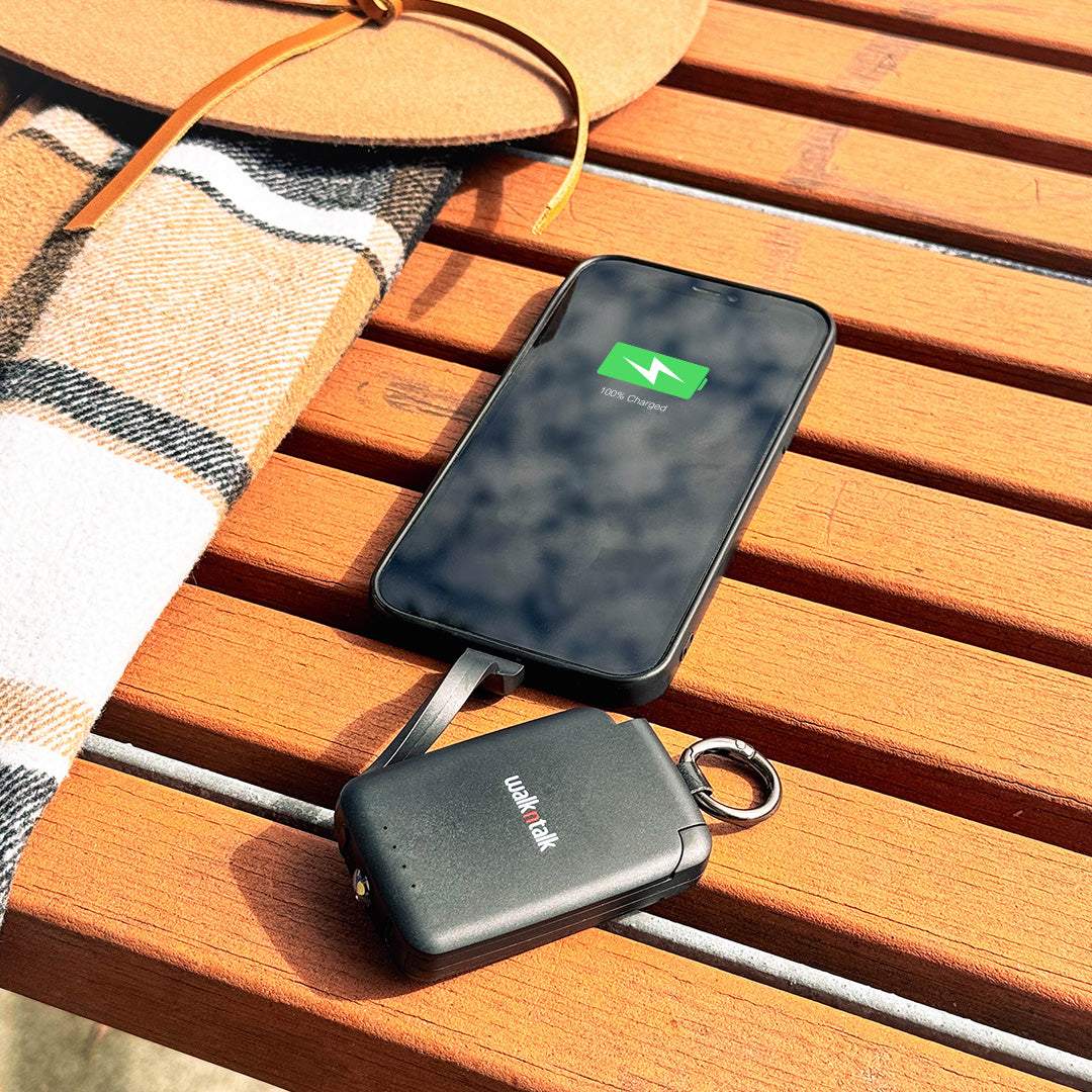 Black Emergency Mini Power Bank charging a phone