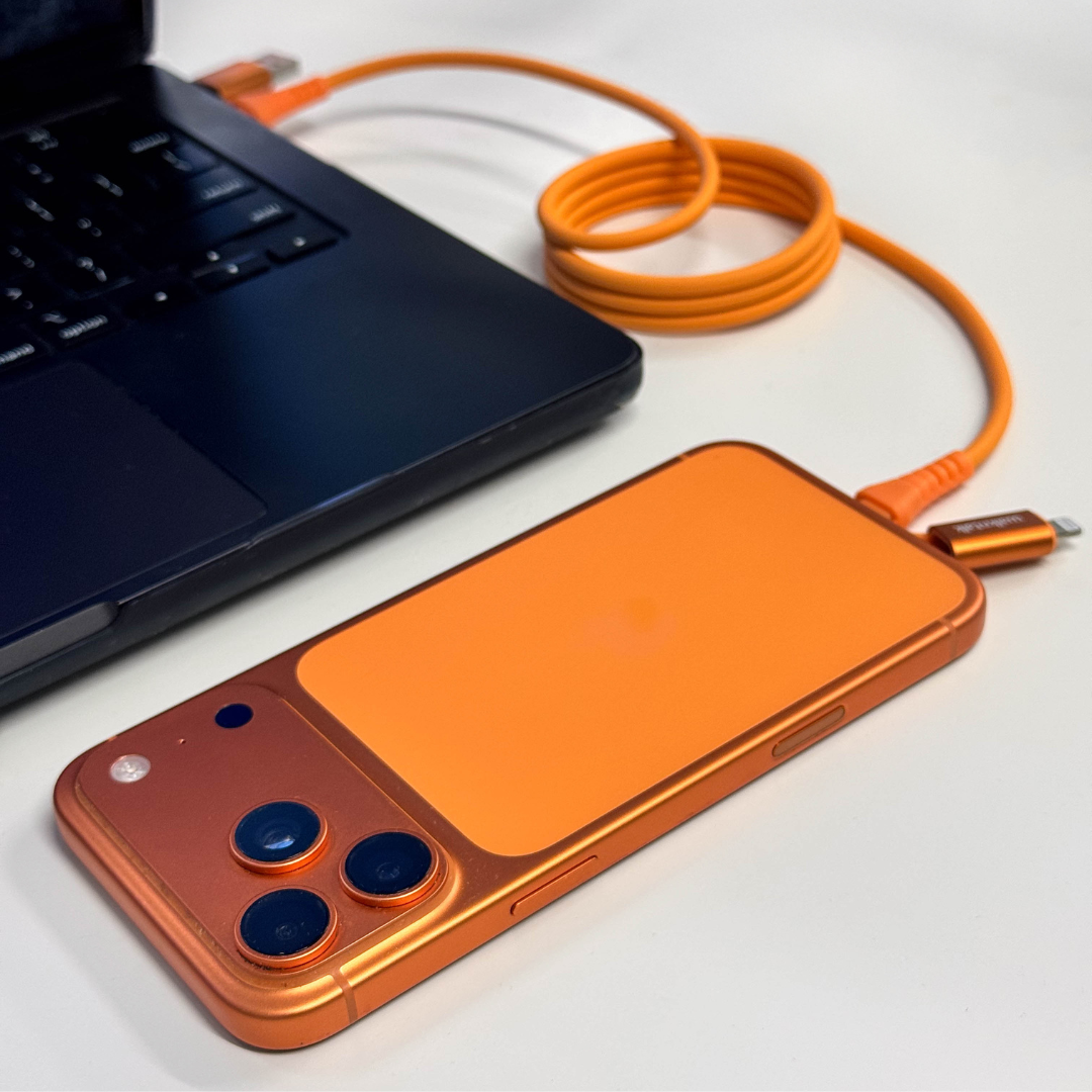Orange 4 in 1 Magnetic Charging Cable connected to orange iphone and laptop