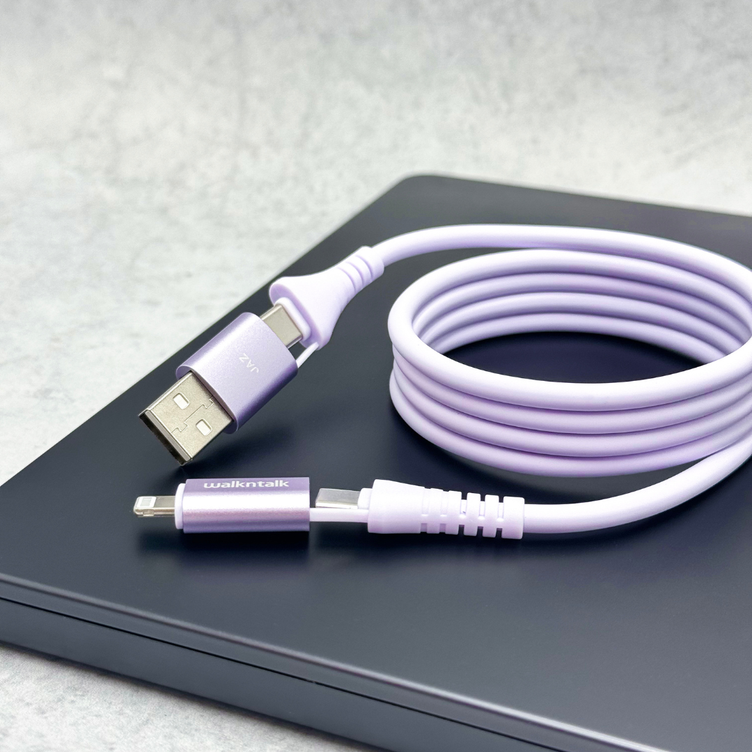 Purple 4 in 1 Magnetic Charging Cable with Lightning and USB C Connectors on a dark laptop