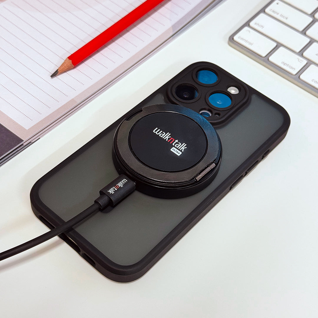 Walkntalk's MagSafe Magnetic Wireless Charger, shown charging a phone laying face down on a desk. 